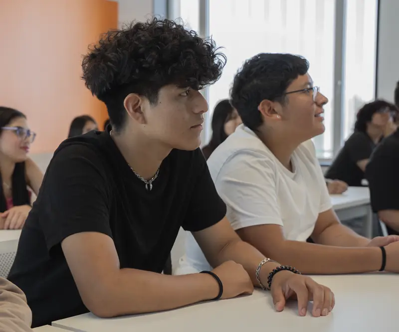 Grupo de alumnos prestando atención durante una clase del curso académico en el centro de formación profesional Nova FP23 en Madrid.